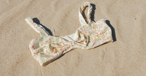 Bikini top in the sand on a beach at a swingers resort