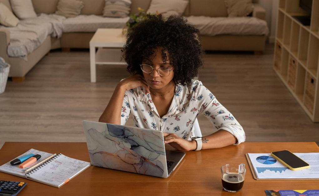 Young woman on her laptop filing for bankruptcy