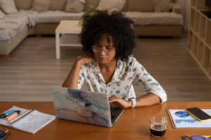 Young woman on her laptop filing for bankruptcy