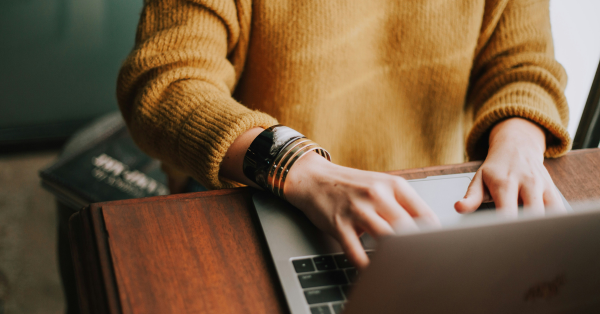 Woman typing on laptop while learning how to file for bankruptcy