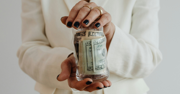 Woman holding jar of cash preparing to file for bankruptcy