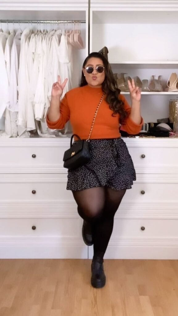 Plus size fall transition outfit with plus size sweater, swing skirt, and plus size black tights for fall